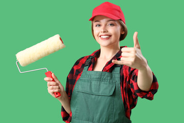Female worker with paint roller showing 