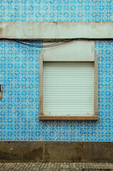 Details of European city architecture, such as windows, doors, walls, electrical wires, signs and tiles. Ordinary elements of urban life in bright colours and high contrast. 
