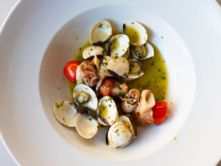 Popular appetizing Spanish dish Squid on a skewer with garlic on a plate