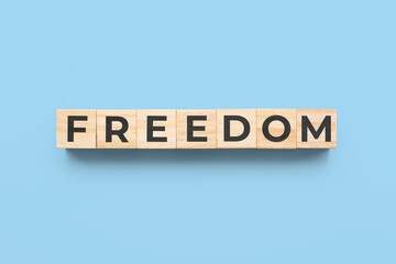 freedom wooden cubes on blue background