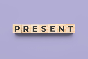 present wooden cubes on purple background
