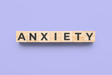 anxiety wooden cubes on purple background