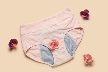 Composition with period panties and beautiful flowers on yellow background