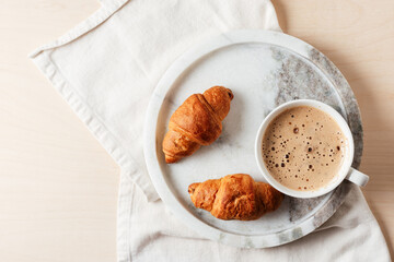 Cup of coffee and croissants.