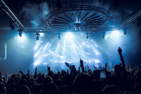 Dynamic concert crowd under vibrant stage lights