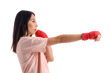 Young Asian woman practicing martial arts on white background