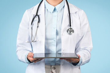 Healthcare professional holding digital tablet