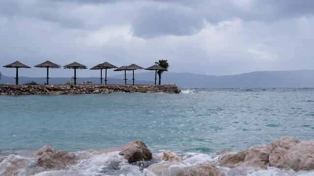 Powerful waves crashing the coast of Njivice, Croatia one day after Storm Ciar&aacute;n smashed into Krk Island. Birds flying slowly above the disquiet sea surface. Cinematic water splashes.