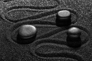 Wandaufkleber Stones on dark sand with lines in Japanese rock garden. Zen concept © Pixel-Shot
