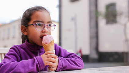 Innocent child eating a sweet ice cream cone