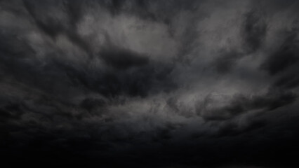 Obraz na płótnie Canvas dark dramatic sky with stormy clouds before rain or snow as abstract background, extreme weather