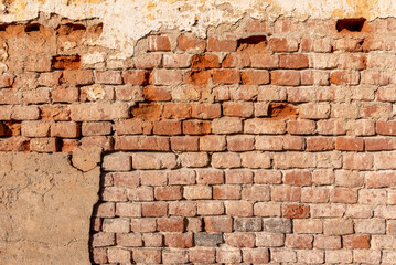Old wall texture with plaster and peeling background with exposed brick. Ideal for background with...