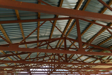 A large ventilated warehouse with a metal roof for storing and drying boards and wooden products. Logging, furniture manufacturing.