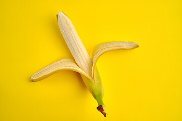 Condom and banana on a yellow background close-up. Sexual health concept
