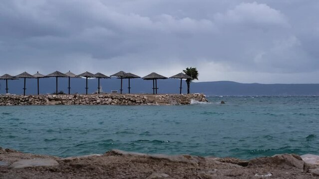 Powerful waves crashing the coast of Njivice, Croatia one day after Storm Ciar&aacute;n smashed into Krk Island. Beautiful rain curtain above the disquiet sea surface. Cinematic water splashes.