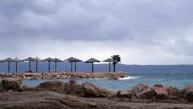 Powerful waves crashing the coast of Njivice, Croatia one day after Storm Ciar&aacute;n smashed into Krk Island. Beautiful rain curtain above the disquiet sea surface. Cinematic water splashes.