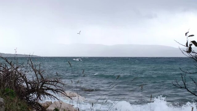 One day after Storm Ciar&aacute;n - also called Emir - smashed into Krk Island with strong winds and driving rain. Beautiful rain curtain above the disquiet wavy sea surface near Njivice, Croatia.