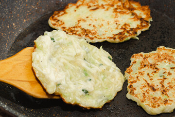 Recipe for zucchini fritters. Step 5 - fry pancakes in pan until golden brown.
