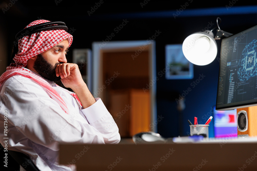 Poster an arab man in traditional attire works at a computer focused on coding, ensures cybersecurity and m