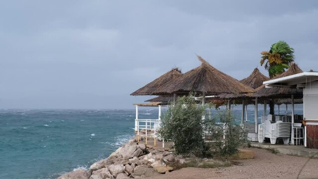 Powerful waves crashing the coast near Njivice, Croatia one day after Storm Ciar&aacute;n smashed into Krk Island. Beautiful rain curtain above the disquiet sea surface. Cinematic water splashes.