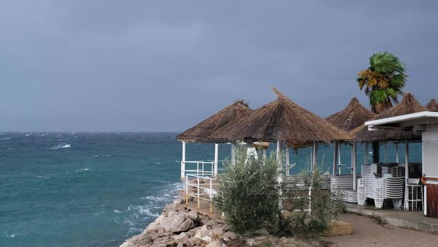 Powerful waves crashing the coast of Njivice, Croatia one day after Storm Ciar&aacute;n smashed into Krk Island. Beautiful rain curtain above the disquiet sea surface. Cinematic water splashes.