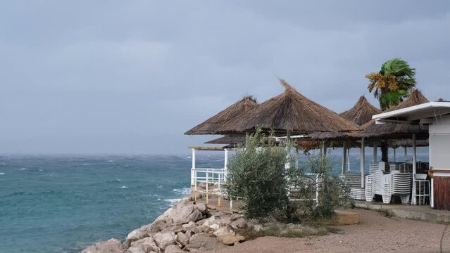 Powerful waves crashing the coast of Njivice, Croatia one day after Storm Ciar&aacute;n smashed into Krk Island. Beautiful rain curtain above the disquiet sea surface. Cinematic water splashes.