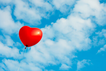 heart shaped balloon in the sky