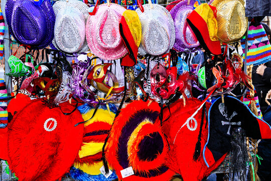 Mardi Gras carnival colorful disguise masks, hats, and feathers background.