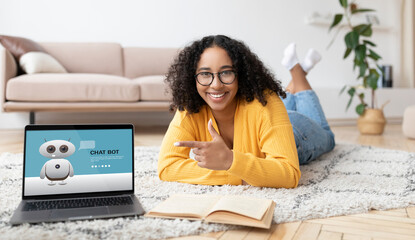 Cheerful black woman student using chat bot on laptop