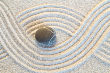 Fototapeta na wymiar Single stone on white sand pattern