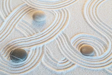 Tuinposter Zen garden with the stones and white sand pattern © images and videos