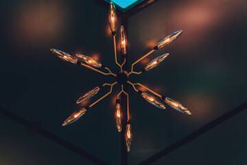 ceiling with adorable chandelier 12 lamps. in the modern restaurant
