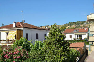 View of the Italian city, the southern city, tiled roofs, green hills. summer sunny day, tourism, family vacation, horizontal photography