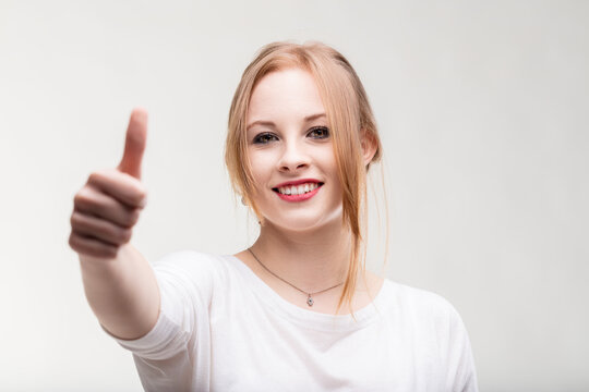 Positive gesture and smile radiate young woman's optimism