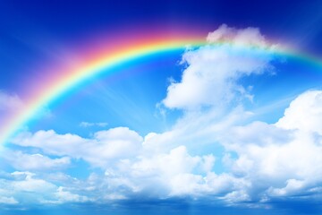 Experience the awe-inspiring beauty of a vibrant rainbow stretching across the vivid blue sky