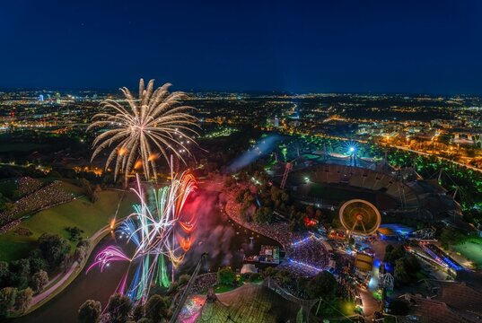 Fireworks over Munich from a high position. The illuminated Olympic Park at night with view from the Olympic Tower, Germany, Europe