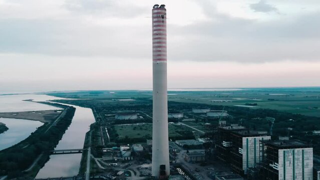 Aerial panoramic shot of the imposing chimney of the decommissioned coal-fired power plant on the Po delta