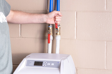 Turning on water flow from water softener. Turning on water supply valve.