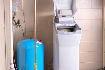Salt based water softener installed in the basement. Residential ion exchange water softener