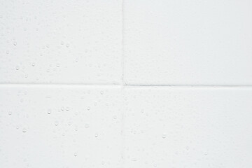 drop of water on white tiles wall texture background.