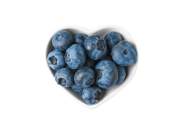 Fresh blueberries in a small heart-shaped bowl isolated on white, transparent background, PNG. Organic berries, healthy food, wild berries. Top view, flat lay