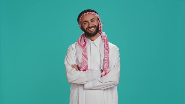 In the studio, islamic person says yes and nods, indicating support and acceptance for things. Middle eastern guy expressing his opinion in studio, showcasing optimism and positivity.