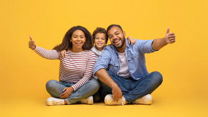 Like Concept. Happy African American Family Of Three Showing Thumbs Up
