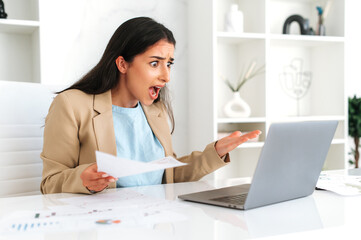 Irritated frustrated arabian or indian business woman, company employee, financial ceo, sit at...
