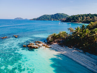 Koh Wai Island Thailand tropical Island near Koh Chang, couple of men and woman on the beach