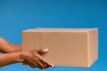 hand holding a cardboard box