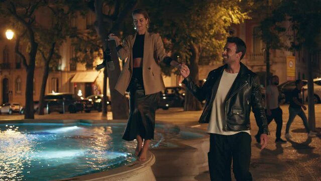 Joyful pair dating park having fun together. Romantic beautiful couple at night