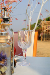 Empty wine glass on table outdoor. Natural light or daylight shot of modern restaurant table set for a lunch.