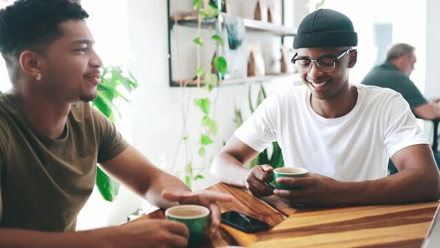 Happy couple of friends, talking at coffee shop and conversation, networking or social hangout at startup cafe. Young people, african students or customer with latte at small business or a restaurant