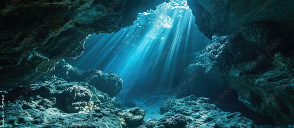 Poster sunlight cascades into the shadows of an underwater cavern in the solomon islands many coral reefs h